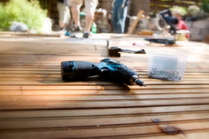 Building a patio with wooden terrace and stones